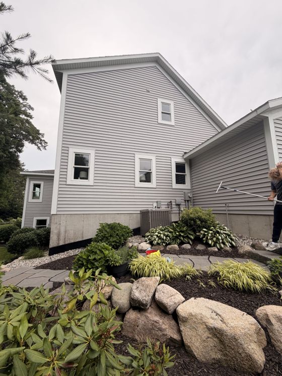 Freshly cleaned windows on the side of a landscaped home
