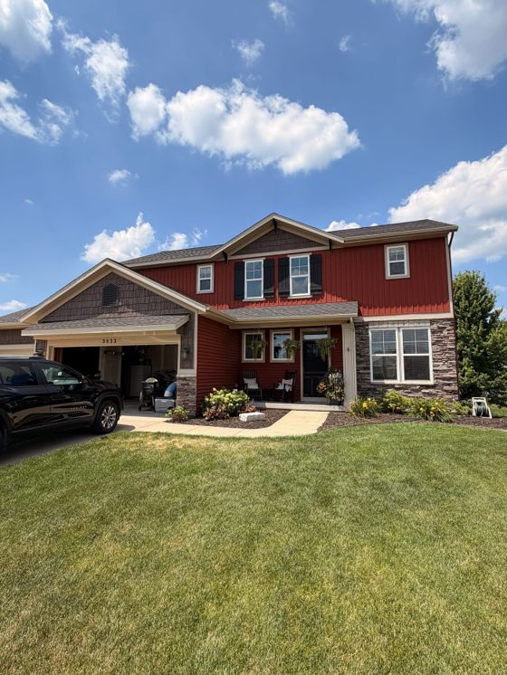Completed exterior window cleaning on a red home