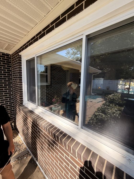 Close view of a large window during a professional exterior cleaning